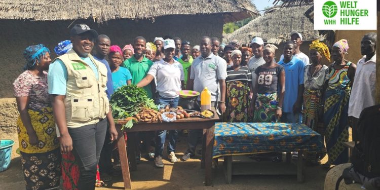 Hawa Bockarie (In WHH Field Gear from left), WHH Field Staff and project participants in Njaluahun Community in preparation for the Cooking Class.